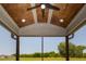 Screened porch with wood paneled ceiling featuring recessed lighting and view of large backyard at 20 Water Willow Ln, Zebulon, NC 27597