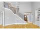 Grand staircase with wood and iron railings, leading to the upper level at 20 Water Willow Ln, Zebulon, NC 27597