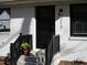 Black front door with sidelights and a small planter on the steps at 213 Drew St, Louisburg, NC 27549