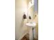 Powder room features a pedestal sink, a decorative mirror, and neutral wall color at 229 Rose Walk Ln, Carrboro, NC 27510