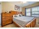 Cozy bedroom features a comfortable bed, natural light, and a wooden dresser at 229 Rose Walk Ln, Carrboro, NC 27510