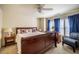 Comfortable bedroom with dark wood furniture, soft carpet, and natural light at 229 Rose Walk Ln, Carrboro, NC 27510