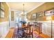 Elegant dining room with hardwood floors, wainscoting, and classic decor, leading to a bright living area at 229 Rose Walk Ln, Carrboro, NC 27510