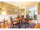 Warm dining room featuring hardwood floors, elegant lighting, wainscoting, and classic decor at 229 Rose Walk Ln, Carrboro, NC 27510