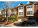 Charming brick townhome featuring an attached garage and manicured landscaping at 229 Rose Walk Ln, Carrboro, NC 27510
