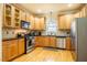 Functional kitchen with wood cabinets, stainless steel appliances, and a convenient breakfast bar area at 229 Rose Walk Ln, Carrboro, NC 27510