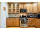 Well-lit kitchen boasts stainless steel appliances, light wood cabinetry, and dark countertops at 229 Rose Walk Ln, Carrboro, NC 27510