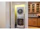 Conveniently located laundry room with a stacked washer and dryer unit and storage cabinets at 229 Rose Walk Ln, Carrboro, NC 27510