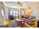 Cozy living room features hardwood floors, ceiling fan, built-in shelving, and a comfortable seating arrangement at 229 Rose Walk Ln, Carrboro, NC 27510