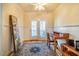 Bright office space featuring hardwood floors, a writing desk, and French doors leading to a balcony at 229 Rose Walk Ln, Carrboro, NC 27510