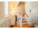 Inviting stairway features hardwood steps and a light wood banister; ample natural light at 229 Rose Walk Ln, Carrboro, NC 27510