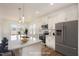 White kitchen features stainless appliances, quartz countertops, and breakfast bar at 231 Trescott St, Smithfield, NC 27577