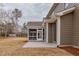 Back of house showing gray siding and screened in porch with backyard at 2401 Terri Creek N Dr # 08, Fuquay Varina, NC 27526