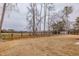 Spacious backyard showing mature trees and a fence at 2401 Terri Creek N Dr # 08, Fuquay Varina, NC 27526
