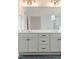 Bathroom vanity with double sinks, white cabinets, and updated lighting at 2401 Terri Creek N Dr # 08, Fuquay Varina, NC 27526