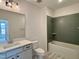 Stylish bathroom with a sleek vanity, white tile, and modern fixtures at 2401 Terri Creek N Dr # 08, Fuquay Varina, NC 27526