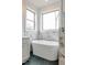 Bright bathroom featuring a soaking tub, marble tiling, and natural light from the window at 2401 Terri Creek N Dr # 08, Fuquay Varina, NC 27526