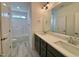 This bathroom features double sinks, green cabinets and a shower-tub combo at 2401 Terri Creek N Dr # 08, Fuquay Varina, NC 27526