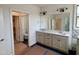 Modern bathroom featuring a double sink vanity, tile flooring, and walk-in closet at 2401 Terri Creek N Dr # 08, Fuquay Varina, NC 27526