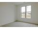 Bright, carpeted bedroom with a large window showcasing a peaceful country view at 2401 Terri Creek N Dr # 08, Fuquay Varina, NC 27526