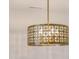 Close-up of a brass chandelier with decorative geometric patterns at 2401 Terri Creek N Dr # 08, Fuquay Varina, NC 27526