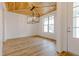 Elegant dining room with wood ceiling, stylish light fixture, and large window offering a view at 2401 Terri Creek N Dr # 08, Fuquay Varina, NC 27526