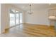 Sun-drenched dining area featuring a modern chandelier and a sliding glass door to outdoor living at 2401 Terri Creek N Dr # 08, Fuquay Varina, NC 27526