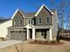 Two-story home with gray siding, white trim, and a two-car garage at 2401 Terri Creek N Dr # 08, Fuquay Varina, NC 27526