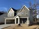 Two-story home with gray siding, white trim, and a two-car garage at 2401 Terri Creek N Dr # 08, Fuquay Varina, NC 27526