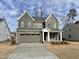 Two-story house with gray siding, a white porch, and a two-car garage at 2401 Terri Creek N Dr # 08, Fuquay Varina, NC 27526