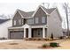 Attractive two-story home with a gray exterior, two car garage, and nicely landscaped yard at 2401 Terri Creek N Dr # 08, Fuquay Varina, NC 27526