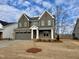 Two-story home featuring neutral siding, a covered porch, and a two-car garage at 2401 Terri Creek N Dr # 08, Fuquay Varina, NC 27526