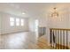 Hallway with wood floors, decorative lighting, and a view of the living area at 2401 Terri Creek N Dr # 08, Fuquay Varina, NC 27526