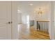 Inviting hallway with wood floors, decorative lighting, and an elegant staircase at 2401 Terri Creek N Dr # 08, Fuquay Varina, NC 27526