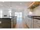 Spacious kitchen featuring an island, hardwood floors, and a view into an adjacent living area at 2401 Terri Creek N Dr # 08, Fuquay Varina, NC 27526