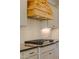 Close up of a gas cooktop with a wooden range hood and white subway tile backsplash in a modern kitchen at 2401 Terri Creek N Dr # 08, Fuquay Varina, NC 27526