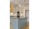 Well-appointed kitchen island with stainless steel appliances, wooden accents, and modern lighting at 2401 Terri Creek N Dr # 08, Fuquay Varina, NC 27526