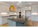 Kitchen showcases a central island with sink and modern faucet, enhancing its functionality and elegance at 2401 Terri Creek N Dr # 08, Fuquay Varina, NC 27526