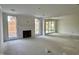 Bright living room features a fireplace, large windows, and a glass sliding door at 2401 Terri Creek N Dr # 08, Fuquay Varina, NC 27526