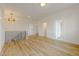 Bright living room with light floors, open doorways, and modern light fixture at 2401 Terri Creek N Dr # 08, Fuquay Varina, NC 27526