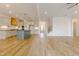 Open-concept floorplan with wood floors and a modern kitchen featuring white cabinets and a blue island at 2401 Terri Creek N Dr # 08, Fuquay Varina, NC 27526
