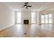 Bright living room showcasing a fireplace with white shiplap and large windows for lots of natural light at 2401 Terri Creek N Dr # 08, Fuquay Varina, NC 27526