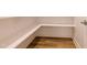 Walk-in pantry with wooden floors and a white shelving unit at 2401 Terri Creek N Dr # 08, Fuquay Varina, NC 27526