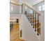 Bright staircase with wooden stairs, black railings, and natural light filling the space at 2401 Terri Creek N Dr # 08, Fuquay Varina, NC 27526