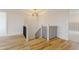 Staircase featuring wood floors, black railings, and a decorative light fixture overhead at 2401 Terri Creek N Dr # 08, Fuquay Varina, NC 27526