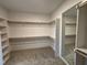 Large walk-in closet featuring shelves and hanging rods at 2401 Terri Creek N Dr # 08, Fuquay Varina, NC 27526