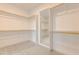 Large walk-in closet with wall-to-wall shelving and a full-length mirror at 2401 Terri Creek N Dr # 08, Fuquay Varina, NC 27526
