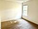 This bedroom has neutral walls and carpet, and a window letting in natural light at 3101 Sawyers Mill Dr, Apex, NC 27539