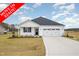 Move-in ready white house with two-car garage and landscaped lawn at 33 Barony Ln, Smithfield, NC 27577