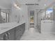 Bathroom with double vanity, white countertops, modern hardware, and a walk-in shower at 5100 Grist Stone Way, Youngsville, NC 27596
